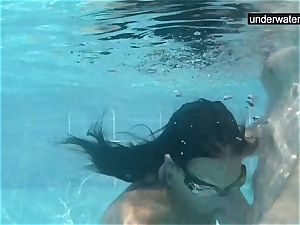submerged underwater with a fuckpole inside her